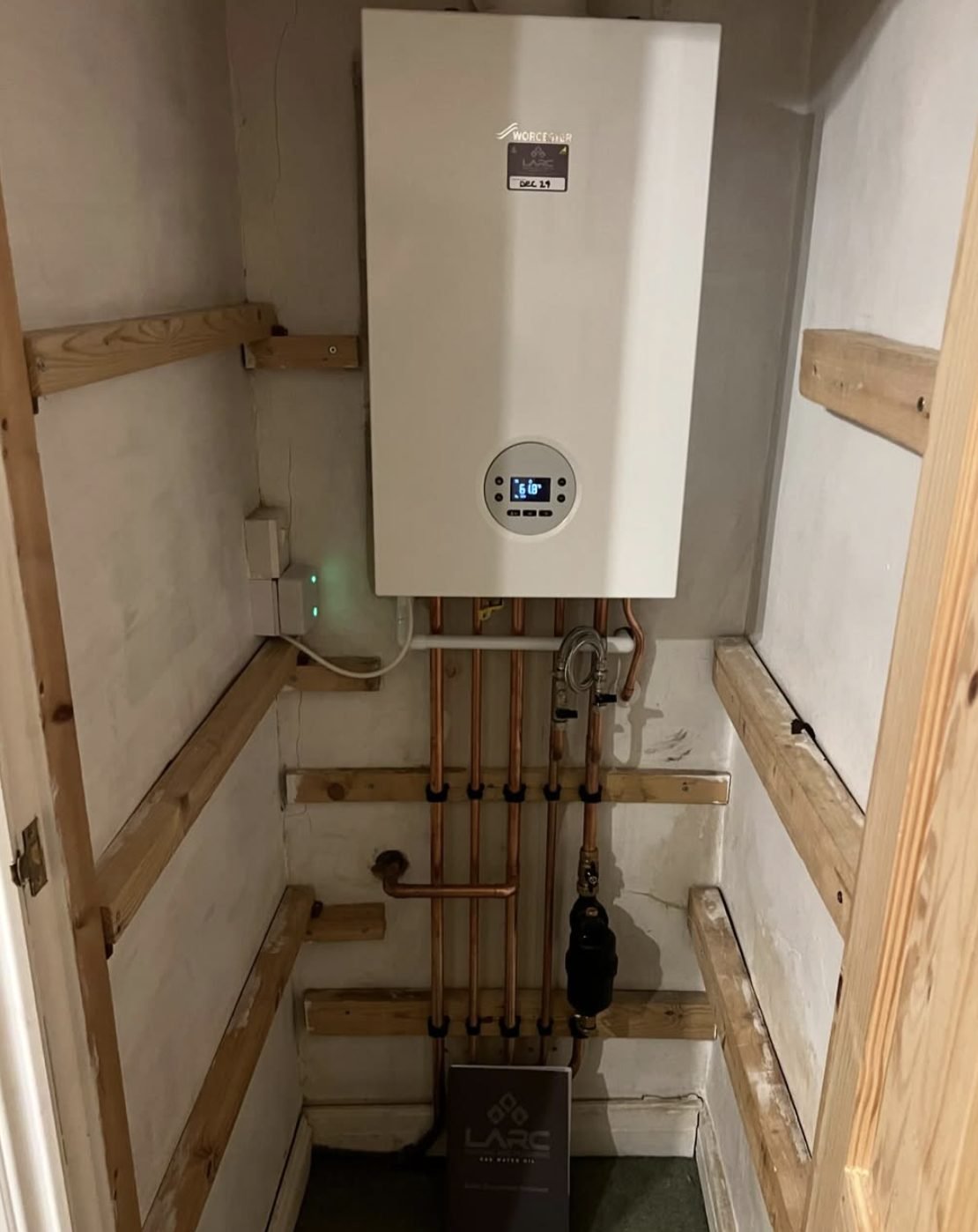 Worcester boiler installed on a stud wall with copper pipework and a magnetic filter